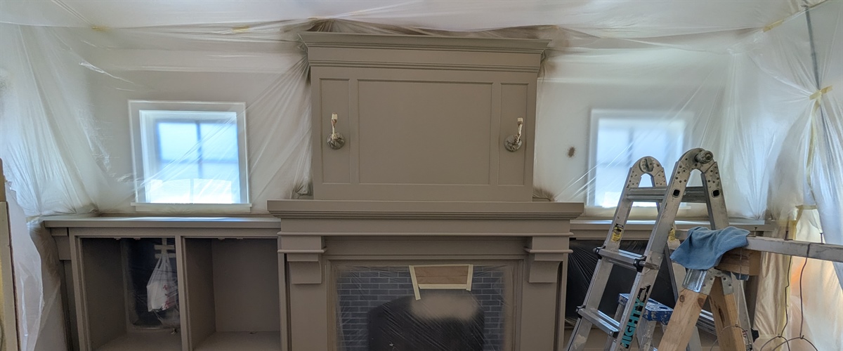 Freshly painted fireplace surround during cabinet painting project in Edina, MN