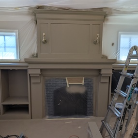 Freshly painted fireplace surround during cabinet painting project in Edina, MN