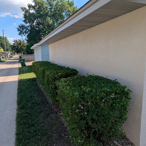 Side view of stucco house painting project in Osseo, MN